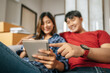 © Johnstocker - Young couple checking boxs relocation in new house
