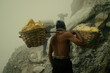 © Scopio - Minners carrying sulfur on top of Kawah ijen through toxic fumes