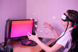 © Scopio - Young man wearing virtual headset sitting at a desk with two computer monitors