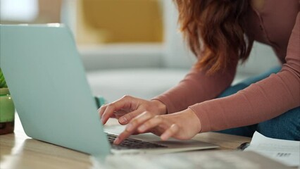 Wall Mural - Woman, hands and laptop typing business email on living room table sitting on sofa at home. Hand of creative female employee in remote work on computer sending online message or research idea indoors