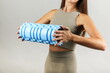 woman holds yoga foam grid roller close up
