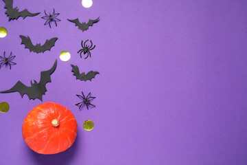 Poster - Flat lay composition with pumpkin, paper bats and spiders on purple background, space for text. Halloween decor