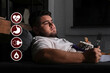 © New Africa - Virtual icons demonstrating different health problems and overweight man eating sweets in living room