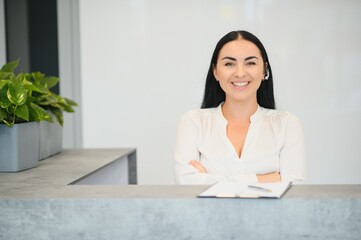 Wall Mural - Picture of pretty receptionist at work.