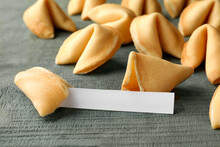 Tasty Fortune Cookies And Paper With Prediction On Blue Wooden Table, Space For Text