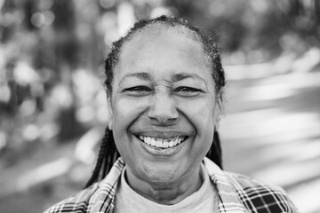 Wall Mural - Portrait of african senior woman into the woods - Focus on eyes - Black and white editing