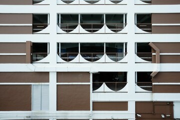 Canvas Print - Balconies of a brown and white building.