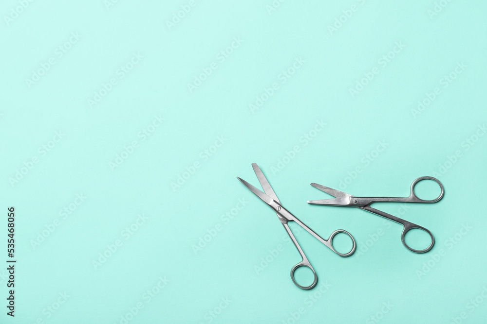 Surgical scissors on color background