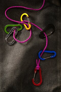 Colourful carabiners on purple rope