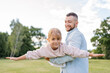 © Julija - Playful handsome bearded Caucasian father having fun with his adorable daughter in park.