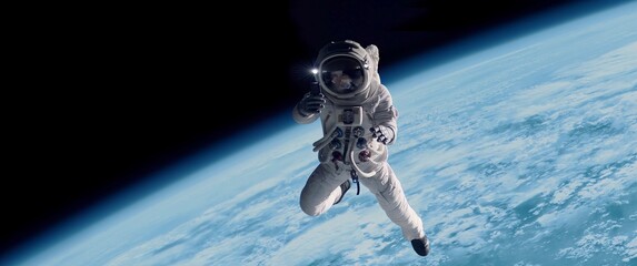 Wall Mural - female astronaut having a video call on her phone while performing space walk in open space, earth i