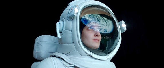 Wall Mural - cu portrait of caucasian female astronaut during spacewalk on the earth orbit. space exploration