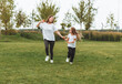 © inna717 - Mother and daughter play and run around the park on a beautiful day. the family is having fun in the park on the grass. morning jog.