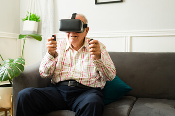 Wall Mural - Happy elderly man enjoying virtual reality technology