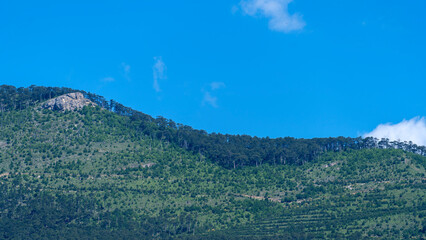 Sticker - Landscape with a white cloud on the background of a mountain and a sky