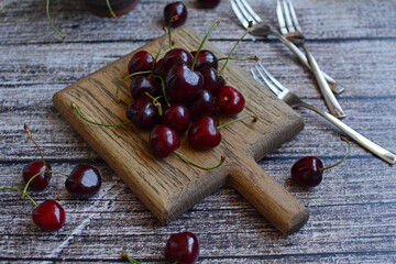 Wall Mural - Ripe cherries on a board close-up. Summer, harvest, season