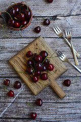 Wall Mural - Layout of juicy cherries on a wooden background. Top view, vertical