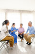 © artitwpd - The caregiver therapist sits with a group of Asian senior people in a circle for checking physical and mental health in a group elderly therapy session. The nursing home facilitates a support group