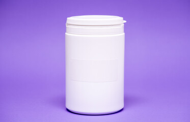 Canvas Print - White plastic jar on a color  background with empty label for text for food or dietary supplements