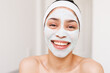 © Wavebreak Media - Portrait of happy biracial woman with beauty face mask in bathroom