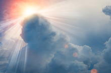 Sun Light Rays Or Beams Bursting From The Clouds On A Blue Sky. Spiritual Religious Background.
