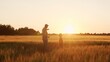 © Acronym - Farmer and his son in front of a sunset agricultural landscape. Man and a boy in a countryside field. Fatherhood, country life, farming and country lifestyle.
