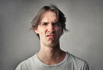 portrait of young man with disgusted expression