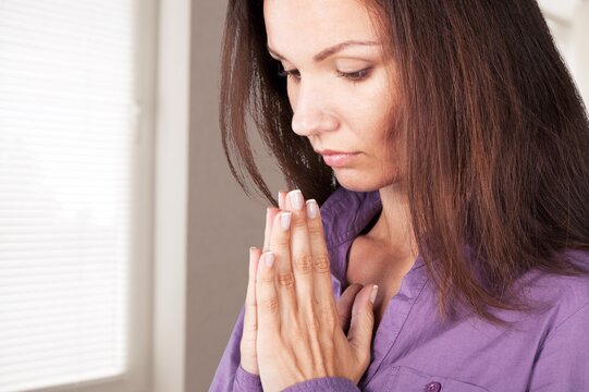 Hopeful young woman pray at home, Christian concept