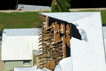 Poster - Hurricane Ian destroyed house roof in Florida residential area. Natural disaster and its consequences