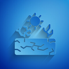 Sticker - Paper cut Drought icon isolated on blue background. Paper art style. Vector