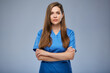 Serious nurse woman in blue medical uniform. Isolated female portrait.