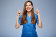 © Yuriy Shevtsov - Smiling nurse woman pointing fingers up. Isolated female portrait.