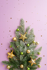 top view vertical photo of christmas tree decorated with gold and green baubles balls star ornaments