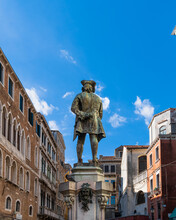 The Monument To The Italian Playwright And Librettist Carlo Goldoni On Campo San Bartolomeo Was Erected In 1883 In The City Of Venice, Italy. Monument To Goldoni With A Walking Stick On Sunny Morning
