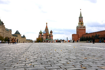 Wall Mural - Defocused view to Kremlin tower and St. Basil's Cathedral on Red square in autumn Moscow