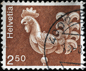 Wall Mural - Rooster-shaped weather vane on swiss postage stamp