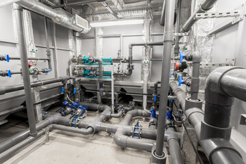 Wall Mural - industrial water treatment. Plastic and metal pipes with fittings, valves
