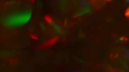 Wall Mural - Abstract Christmas motion background. Red and Green defocused circles shimmer, shine and sparkle. Lens effect. New Year's lights moving. Colorful gradient transitions. 