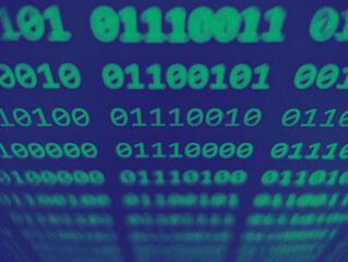closeup view of binary computer code with 1s and 0s displayed on a screen with focus blur effect in 