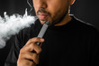 Close-up mouth of man smoke inhaling, breathing and smoke electronic cigarette.
