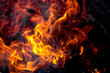 © Anoo - Burning fire close up. Bright orange and red flames on a dark background. Open flame heating. Problems with heating and gas.