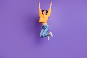 Sticker - Full size photo of young crazy excited woman jump trampoline fists up good mood winner celebrate her vacation day isolated on purple color background