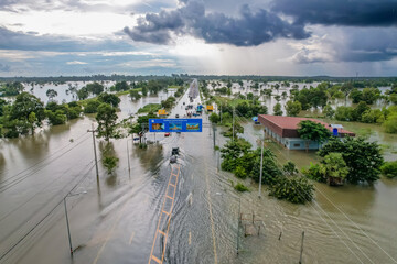 Wall Mural - High-angle view of the Great Flood, Meng District, Thailand, on October 3, 2022, is a photograph from real flooding. With a slight color adjustment
