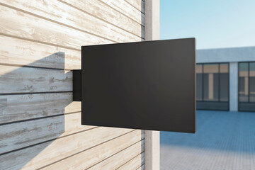 Wall Mural - Empty rectangular black stopper on wooden building. Bright city with sunlight background. Ad, pub, cafe, or restaurant banner. Mock up, 3D Rendering.