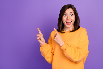 Canvas Print - Photo of young funky excited positive lady wear yellow sweater unexpected fingers pointing empty space halloween event isolated on purple color background