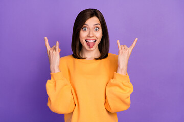 Sticker - Portrait photo of young pretty gorgeous nice adorable woman wear orange shirt showing rock symbol lover tongue out isolated on violet color background