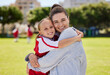 © N Lawrenson/peopleimages.com - Portrait of mother and girl hug at soccer training, bonding and embracing on a field. Sport, fitness and support by parent for child hobby and passion, enjoying morning activity and football outdoor