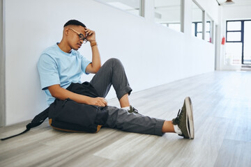 Poster - Depression, mental health and student thinking on a floor, stress and social anxiety at university. Fear, debt and bully risk by black man hiding in an empty lobby, looking hopeless and overwhelmed