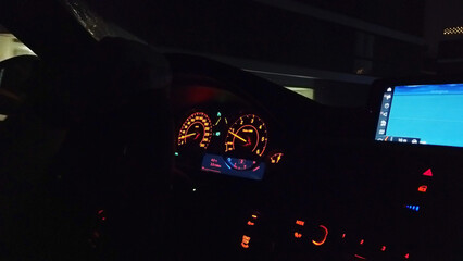 Sticker - Interior of dark car with lights on screen and dashboard