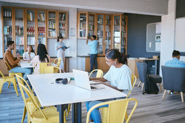 Wall Mural - Students, laptop and modern library for education, learning and study on school campus. Men, women or people with technology for homework, university research and scholarship review for future growth